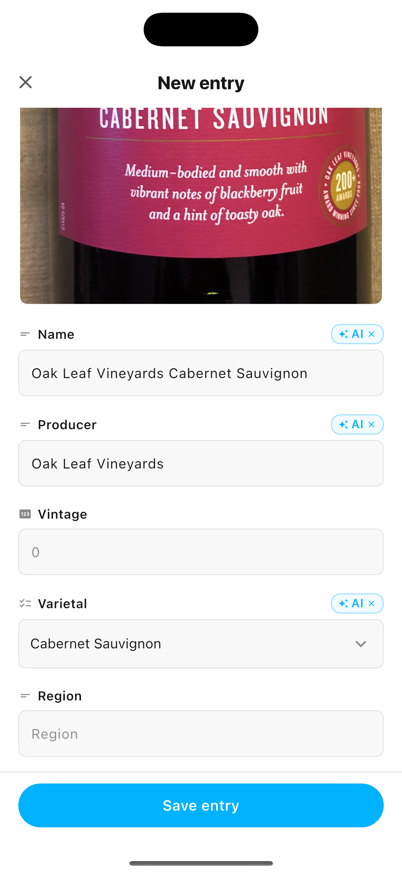 An entry after AI autofill: the photo of a wine bottle at the top, and the name, producer and grape filled in below, each marked AI